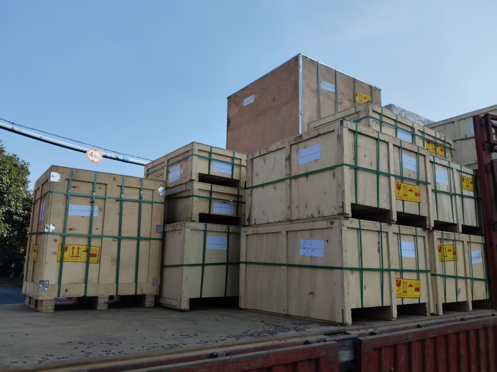 Heavy-duty plywood boxes with green strapping belts ensuring safe transport of graphite parts.