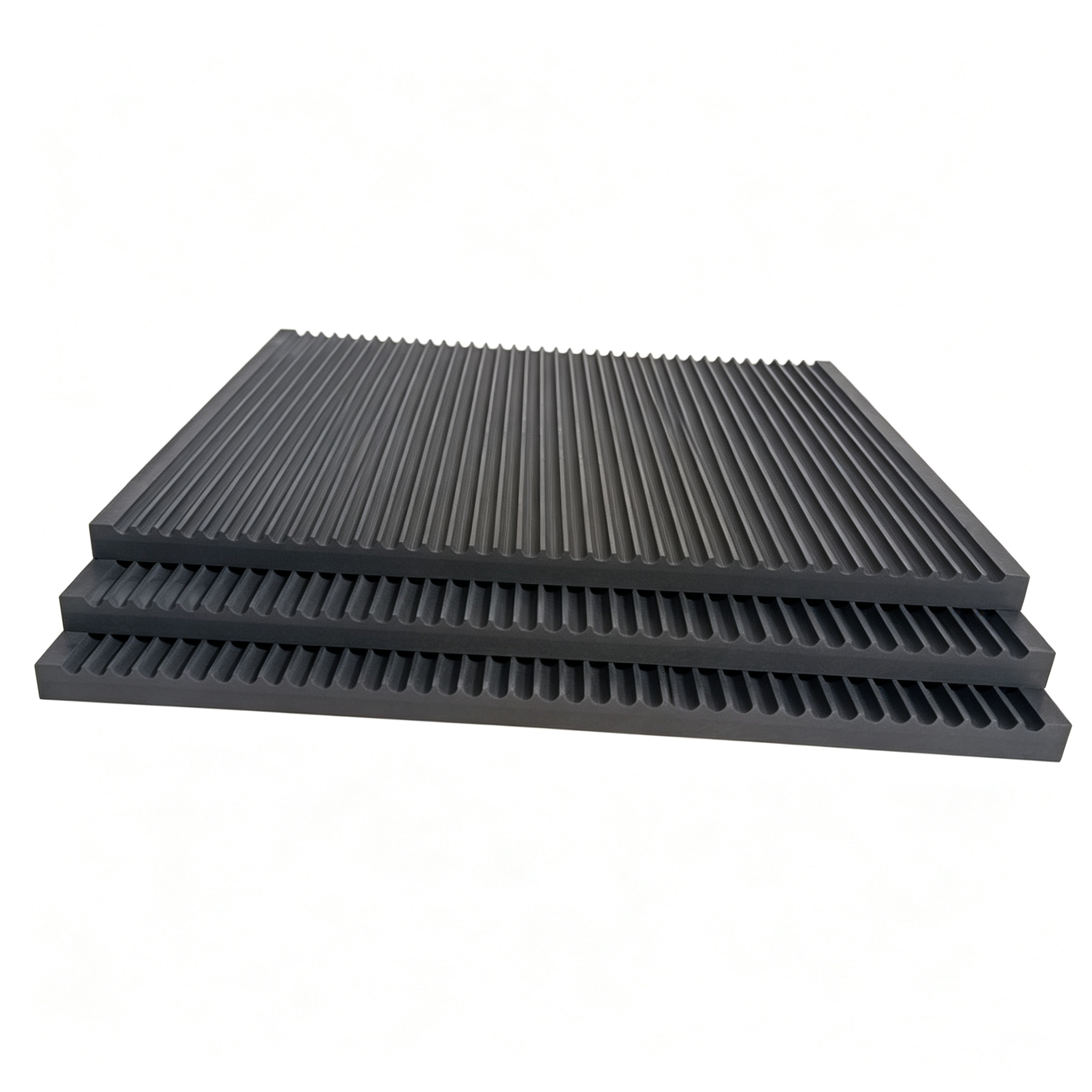 Three stacked grooved graphite plates showing consistent groove quality across batch production