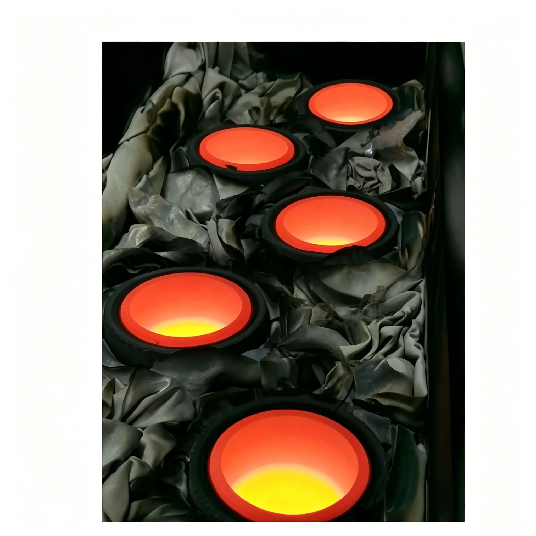 High purity graphite crucibles glowing during aluminum evaporation in vacuum coating chamber, showing uniform heating and long service life