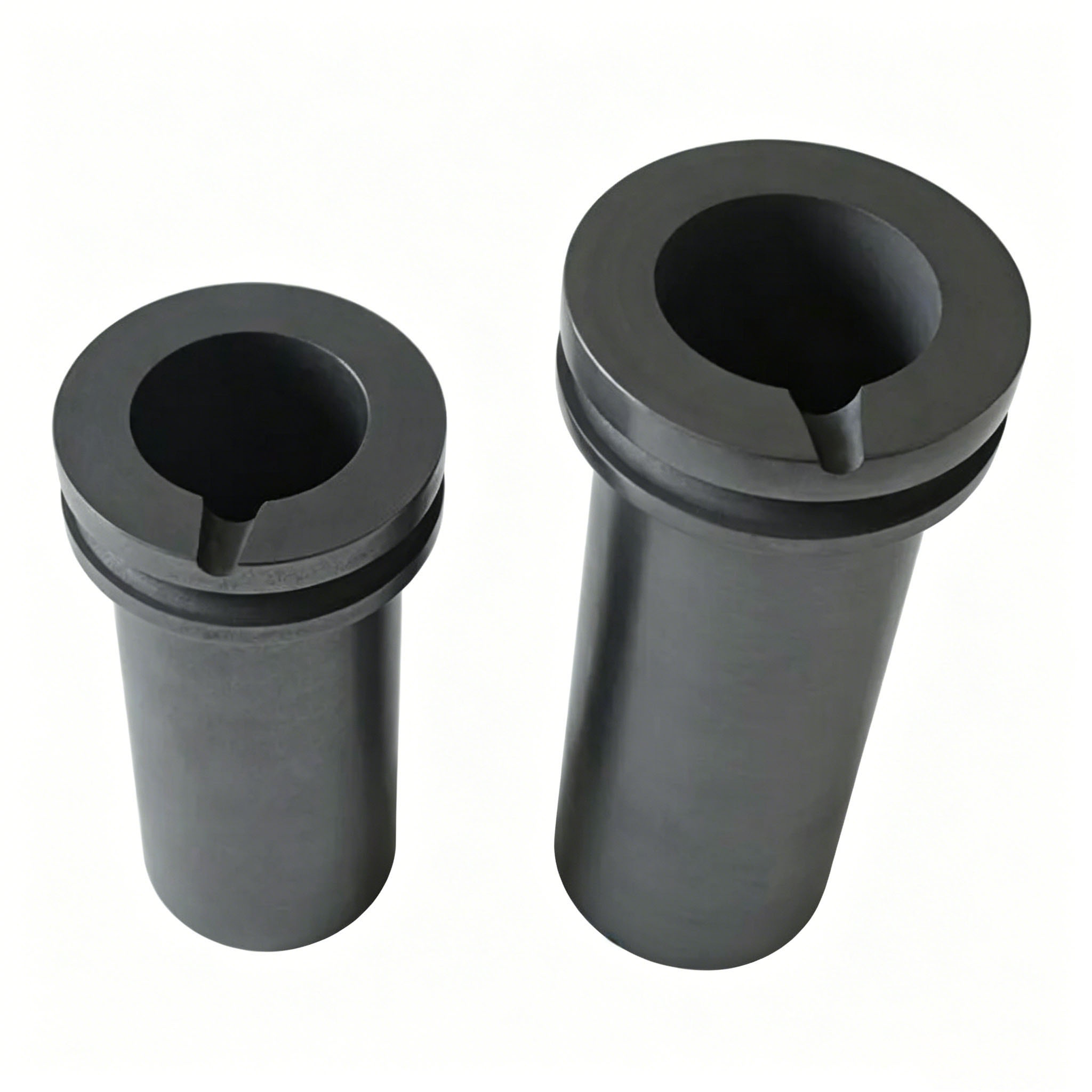 Two double ring graphite crucibles standing side by side, polished graphite surface, professional product display
