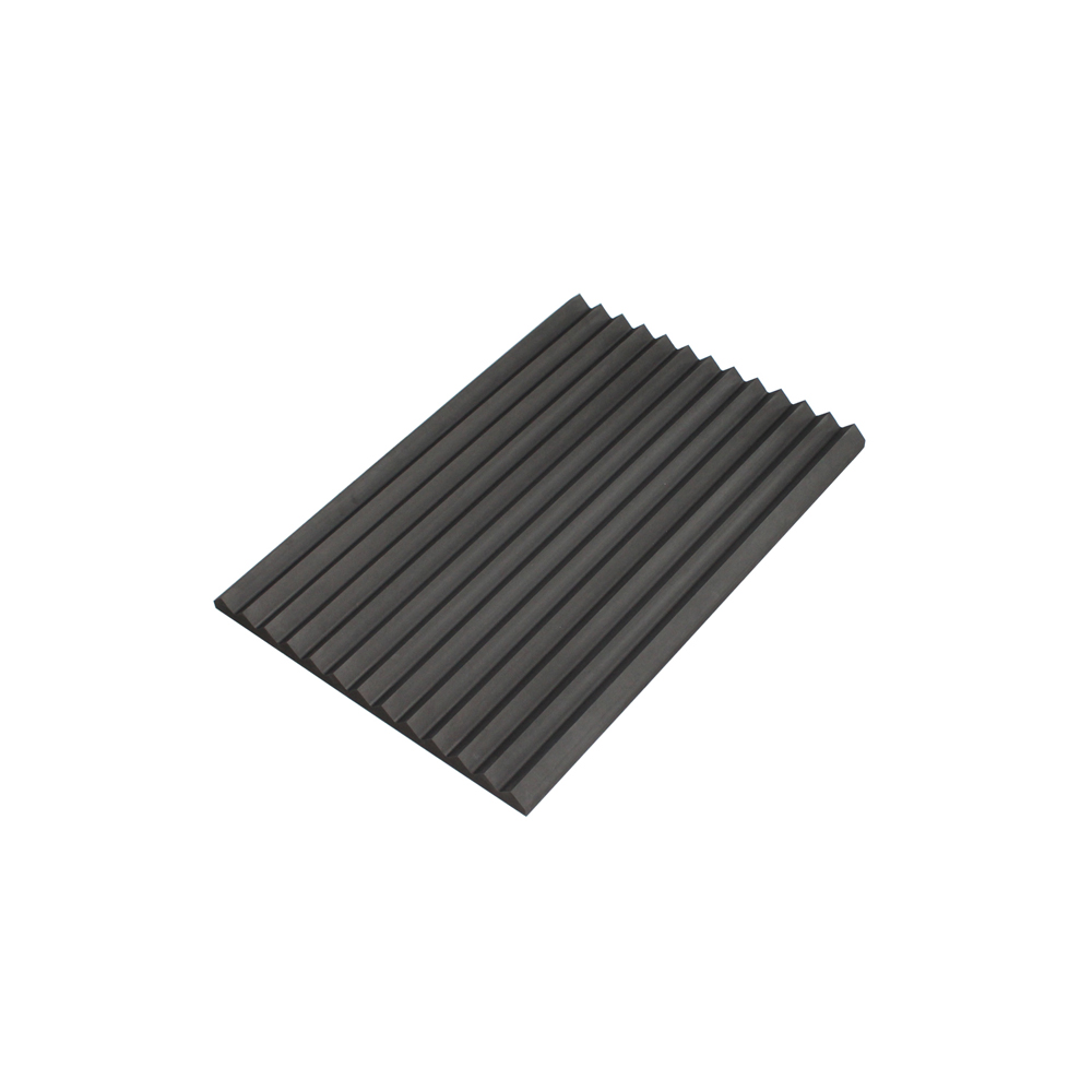 Angled view of dark gray V-groove graphite plate showing precise groove geometry and flat base for industrial mounting