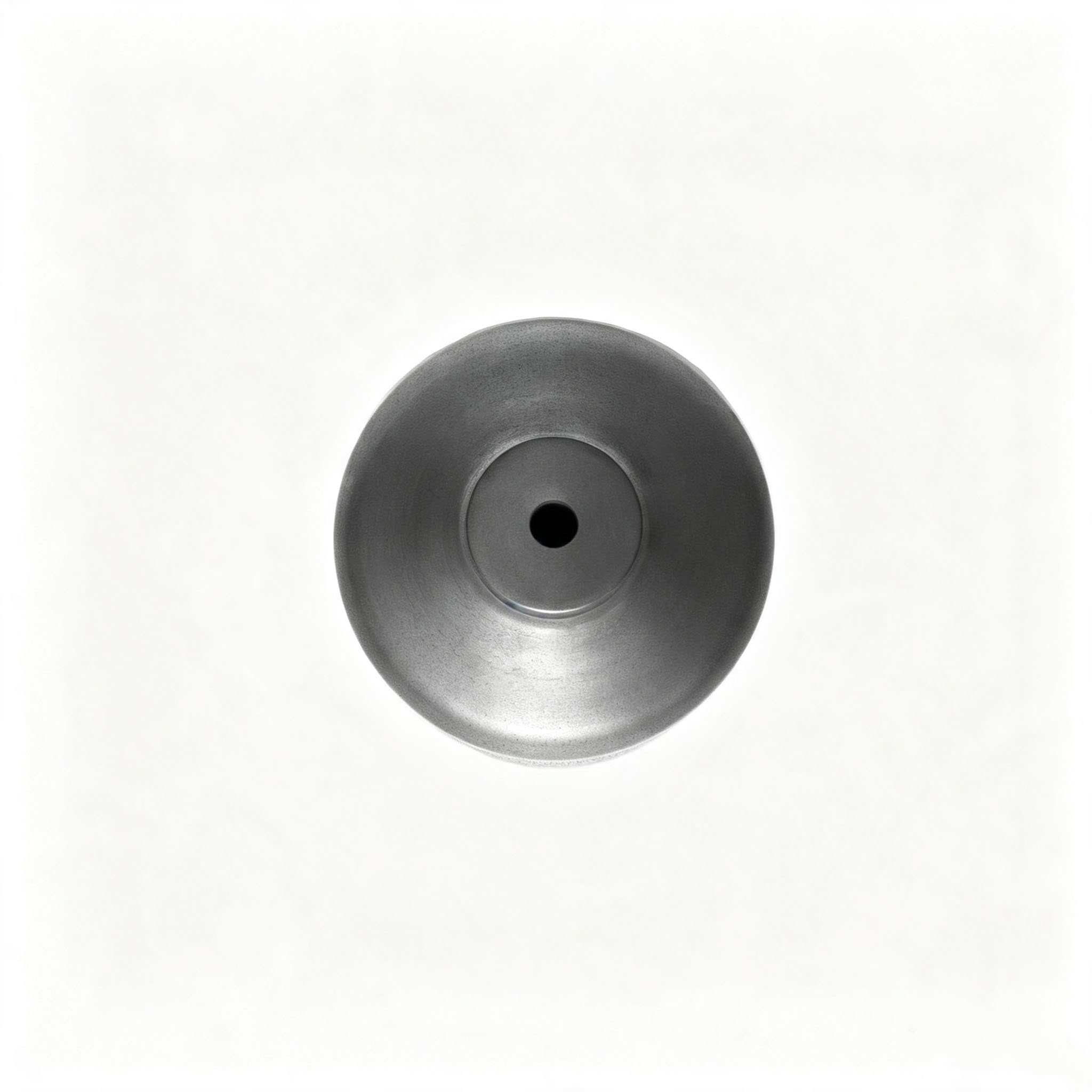 Top-down shot of precision machined graphite crucible with smooth center discharge hole, dense isostatic graphite material for stable molten metal pouring