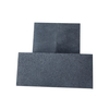 Three pieces of 0.8mm medium grain vibration molded graphite blocks showing natural coarse particle texture, density 1.72g/cm³, ideal for powder metallurgy molds and EDM electrodes