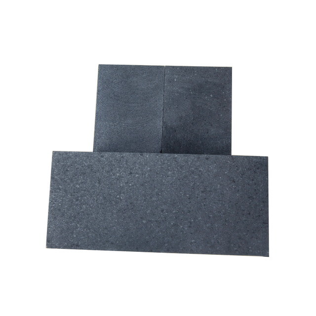 Three pieces of 0.8mm medium grain vibration molded graphite blocks showing natural coarse particle texture, density 1.72g/cm³, ideal for powder metallurgy molds and EDM electrodes