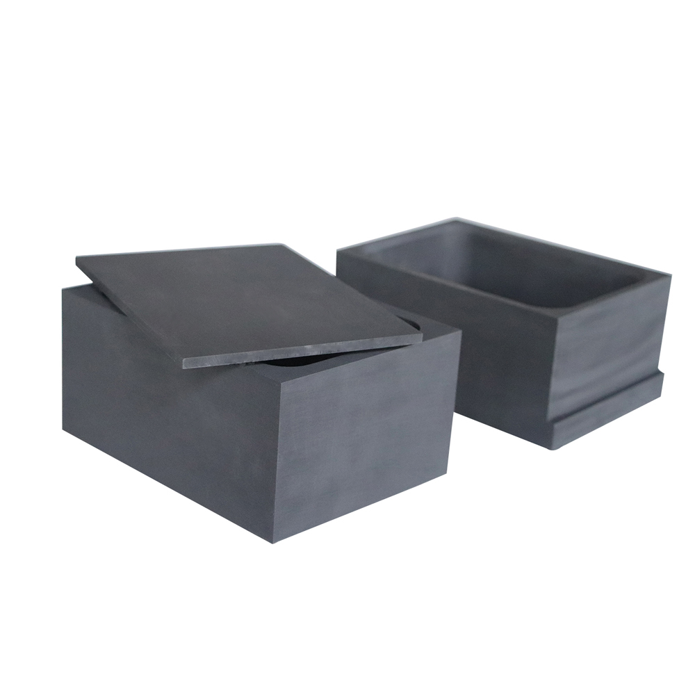Graphite sagger with tilted lid revealing precise sealing fit surface and flat mating joint for inert atmosphere protection during heat treatment