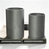 Graphite crucible size comparison two units on factory pallet, tall and short cylindrical crucibles for different furnace capacities, industrial melting containers NHD Carbon China direct manufacturer
